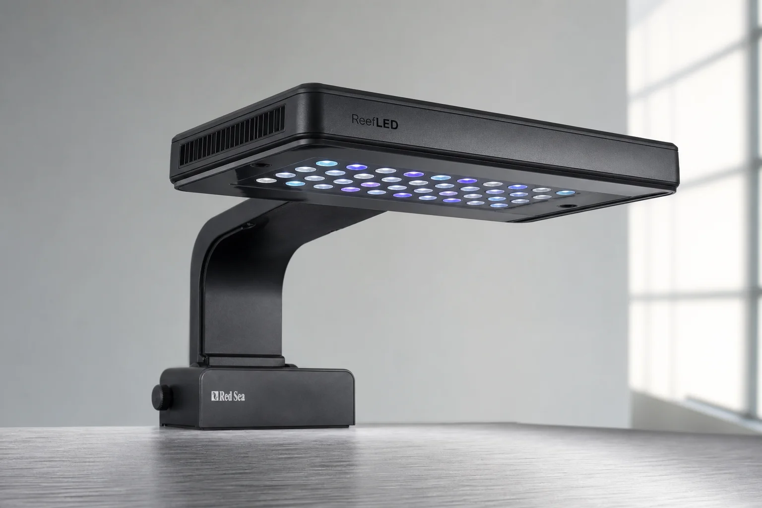 AI Prime 16HD and Red Sea ReefLED aquarium lights on dark surface