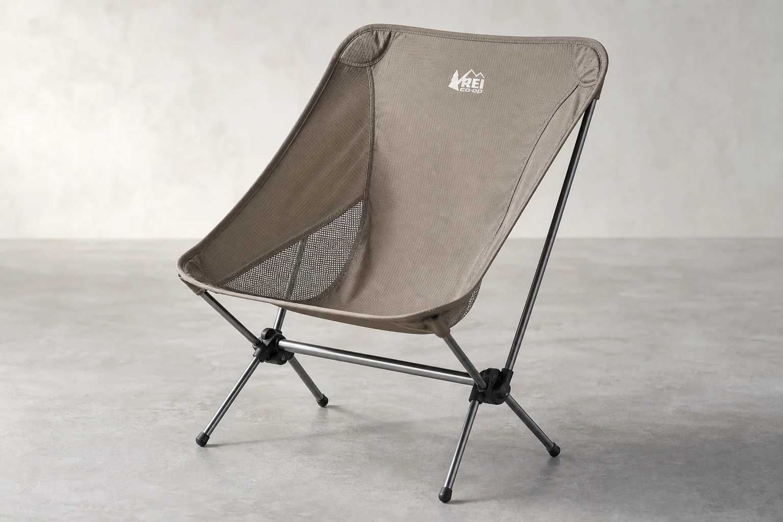 Helinox Chair Zero and REI Co-op Flexlite Air backpacking chairs side by side on neutral backdrop