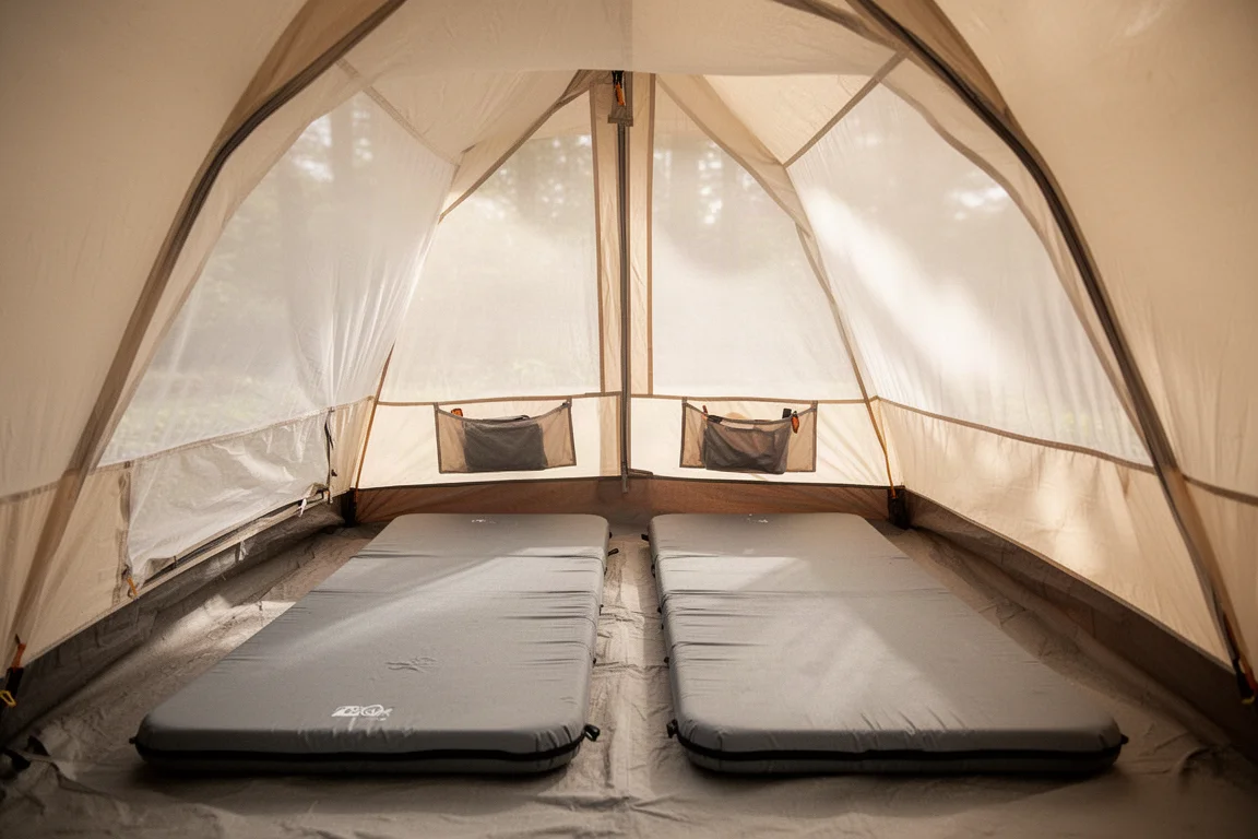 Backpacking tent pitched on an exposed ridge at first light in strong wind