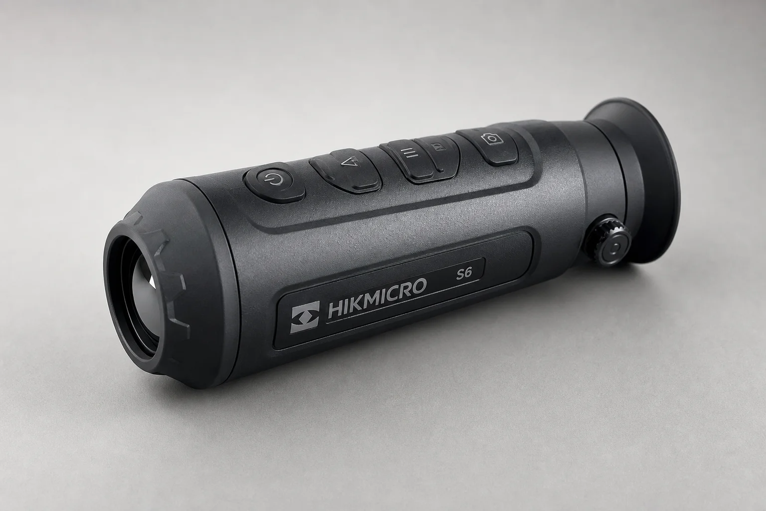 Five thermal imaging scopes displayed on concrete surface