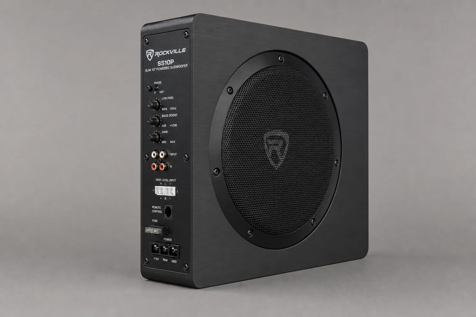 Five compact under-seat subwoofers arranged on dark surface showing various models and sizes