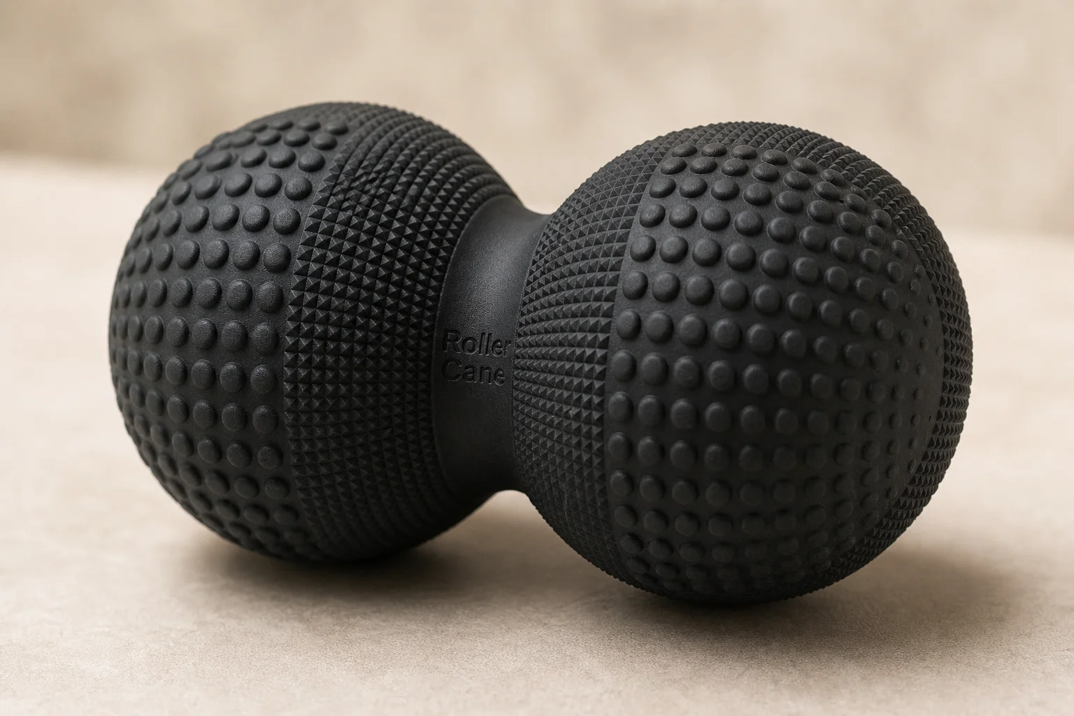 Close-up of Roller Cane's peanut-shaped rubber massage ball texture and design