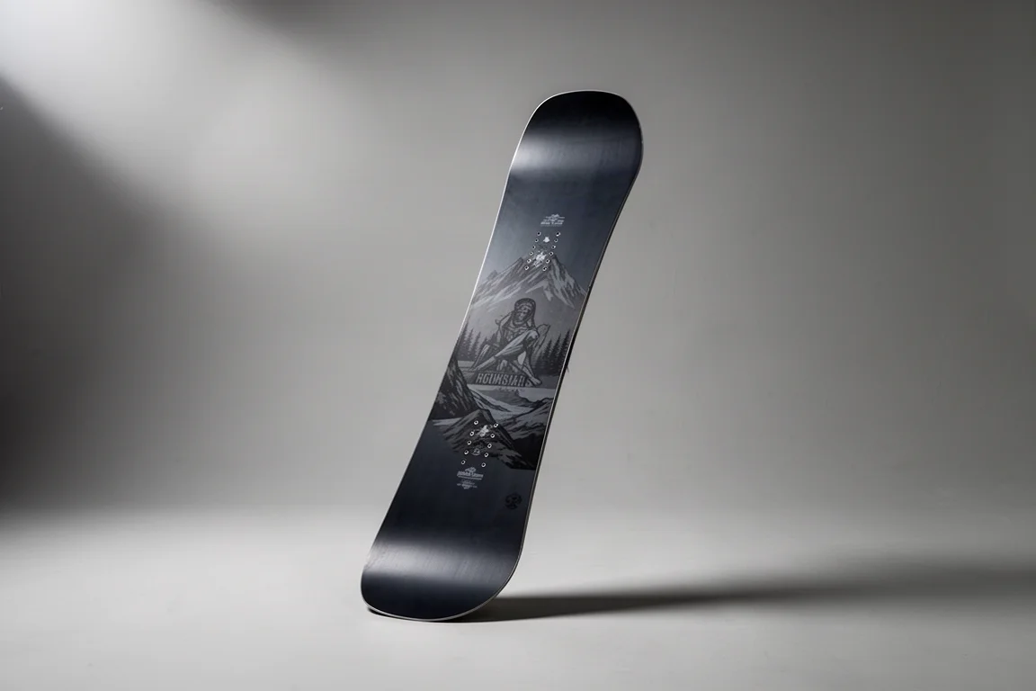 All-mountain freestyle snowboard standing upright on a neutral grey studio backdrop
