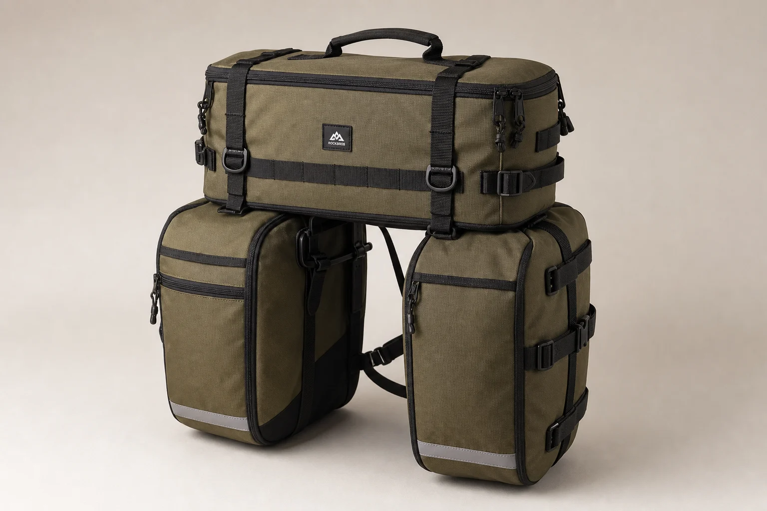 Five bike pannier bags in different styles and sizes arranged on concrete