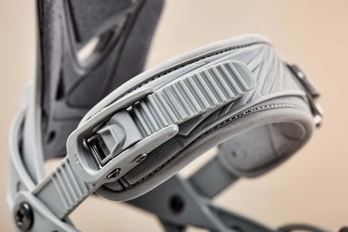 Close-up of a ratchet strap and buckle on a snowboard binding