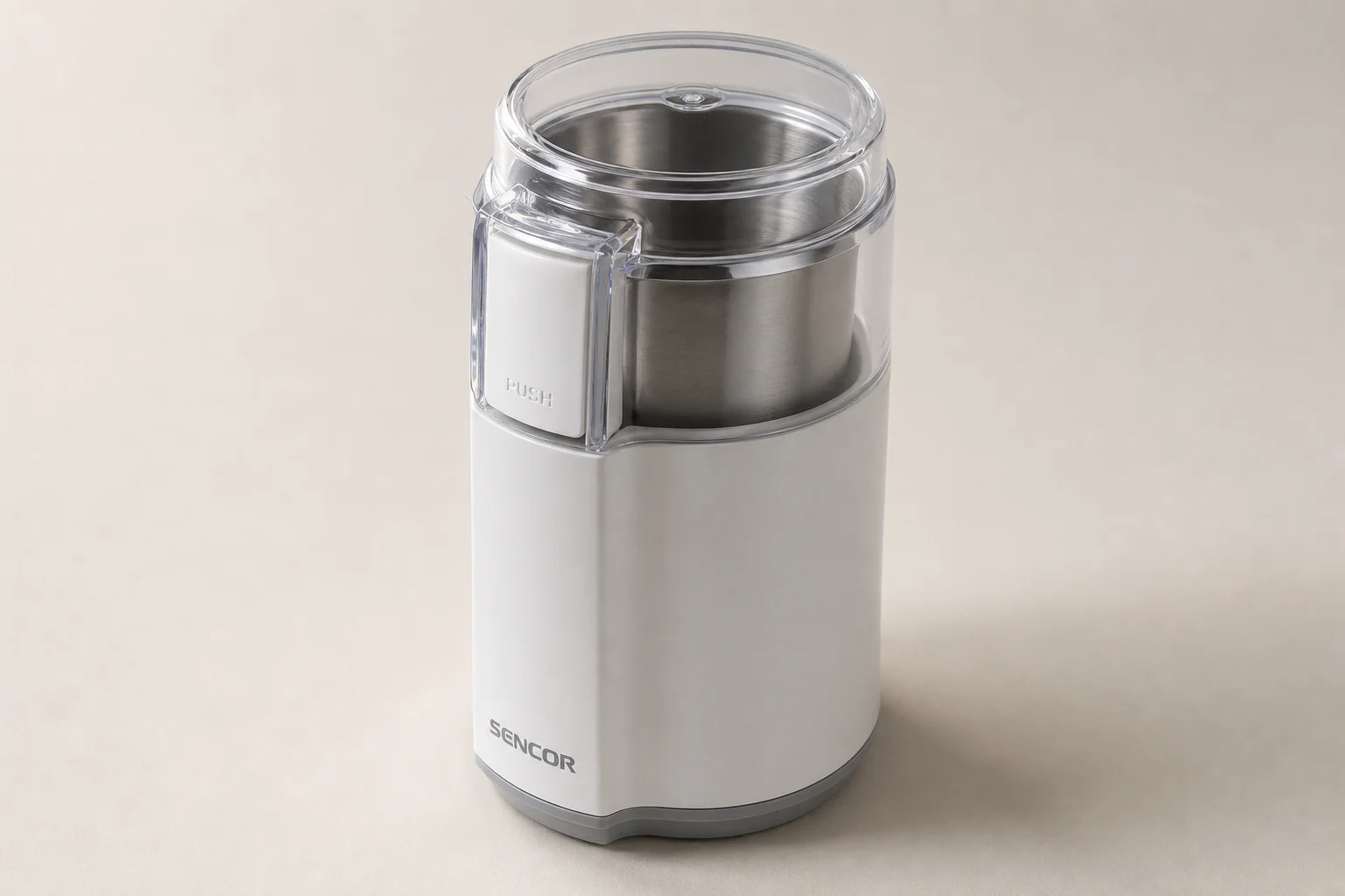 Five coffee grinders from budget electric to commercial bulk models arranged on concrete