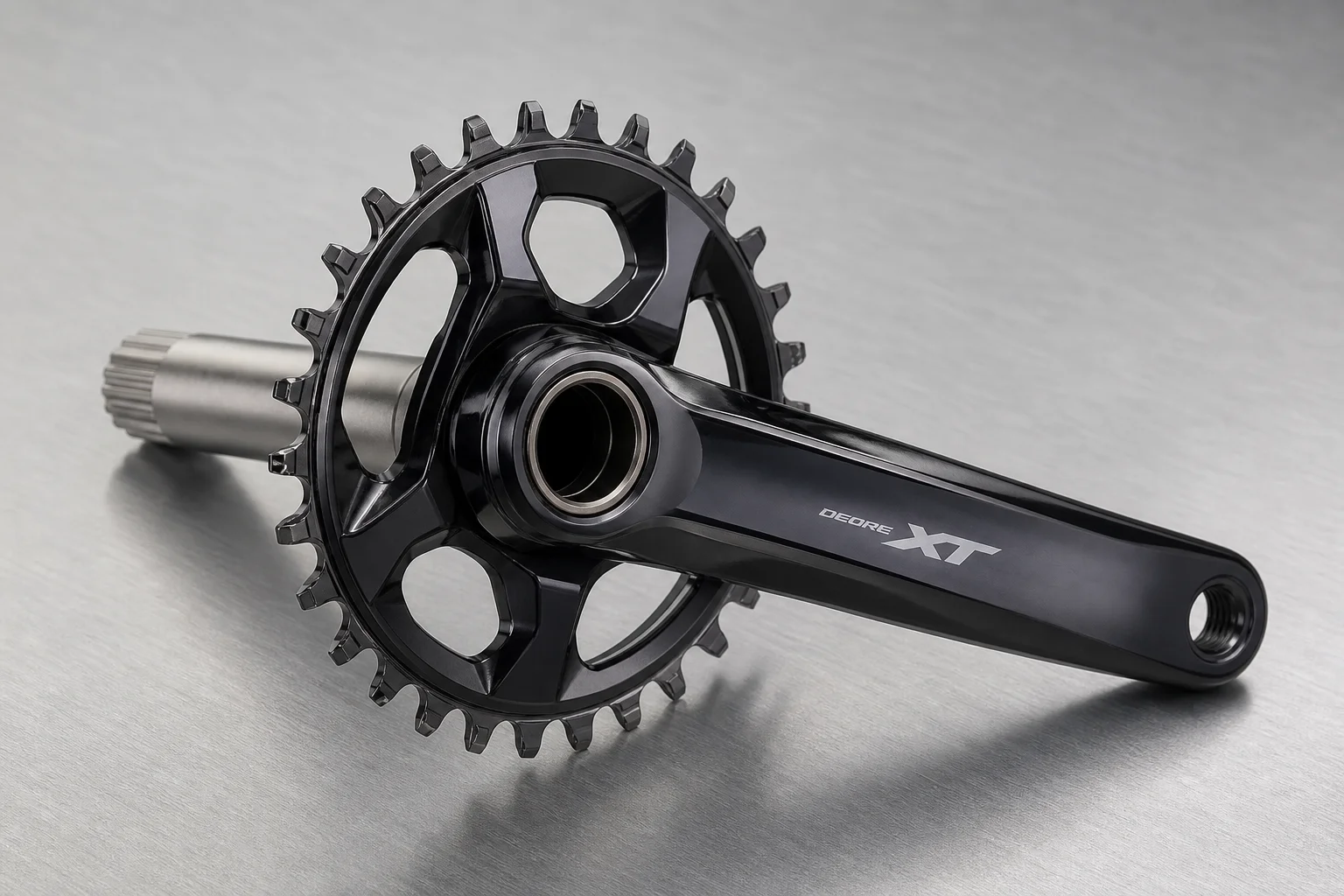 Shimano XT M8200 crankset with glossy two-tone finish on neutral grey surface