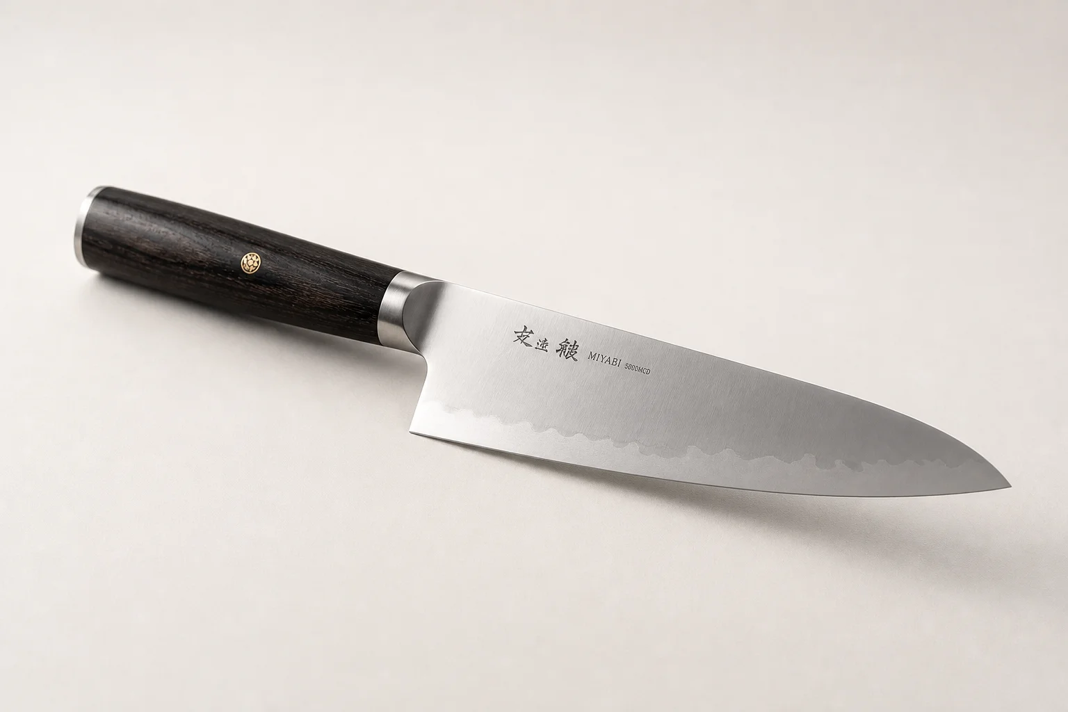 Five chef knives arranged in a row showing different handle styles and blade designs