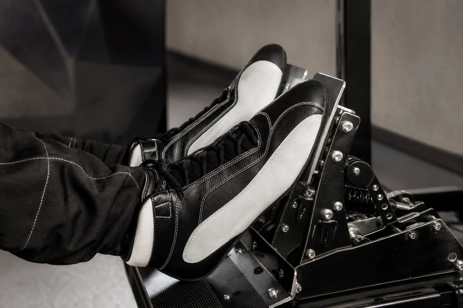 Sim racer performing heel-toe downshifting with racing shoes on pedals