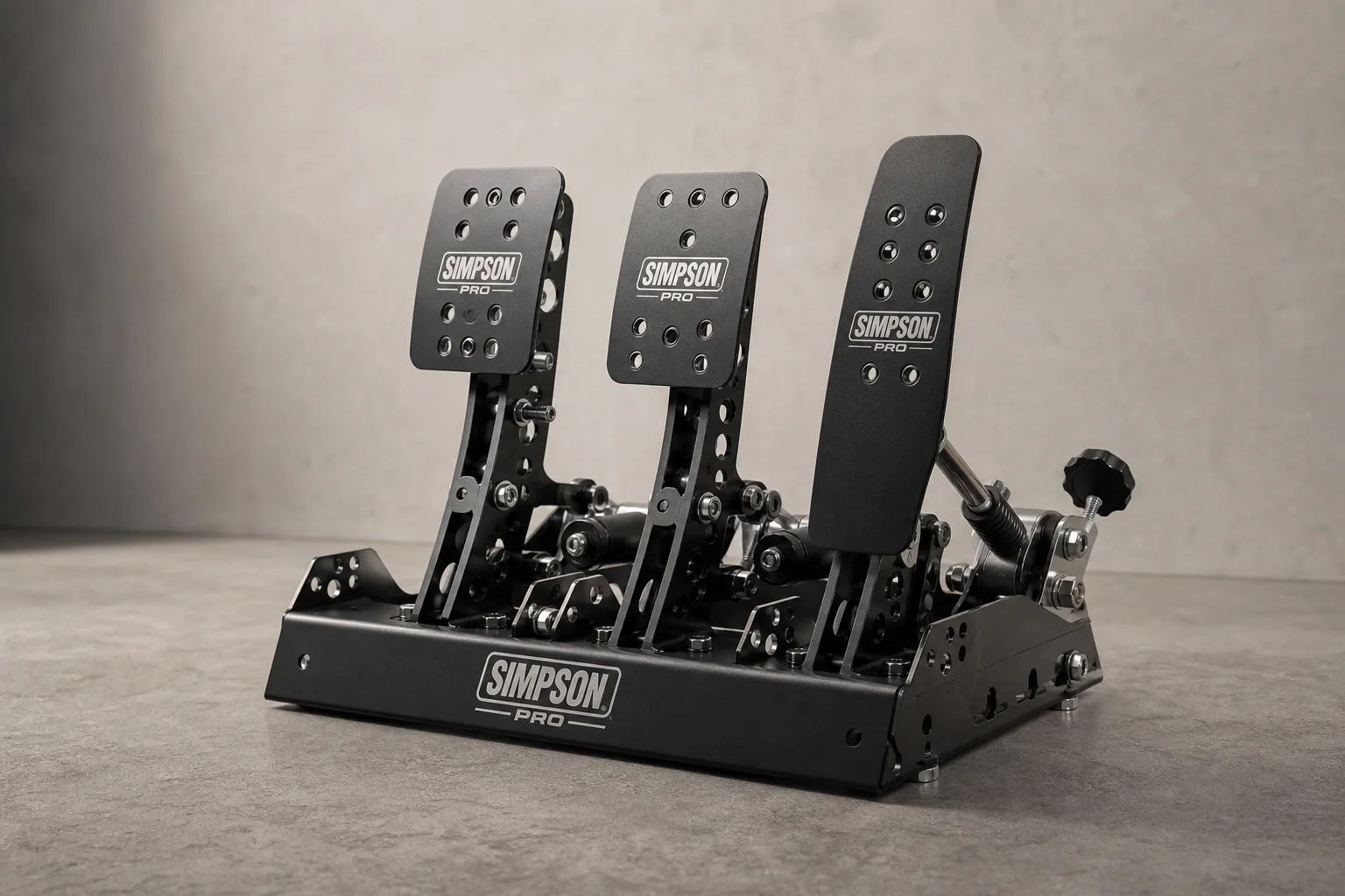 Simpson Pro sim racing pedals set on concrete surface showing all three pedals