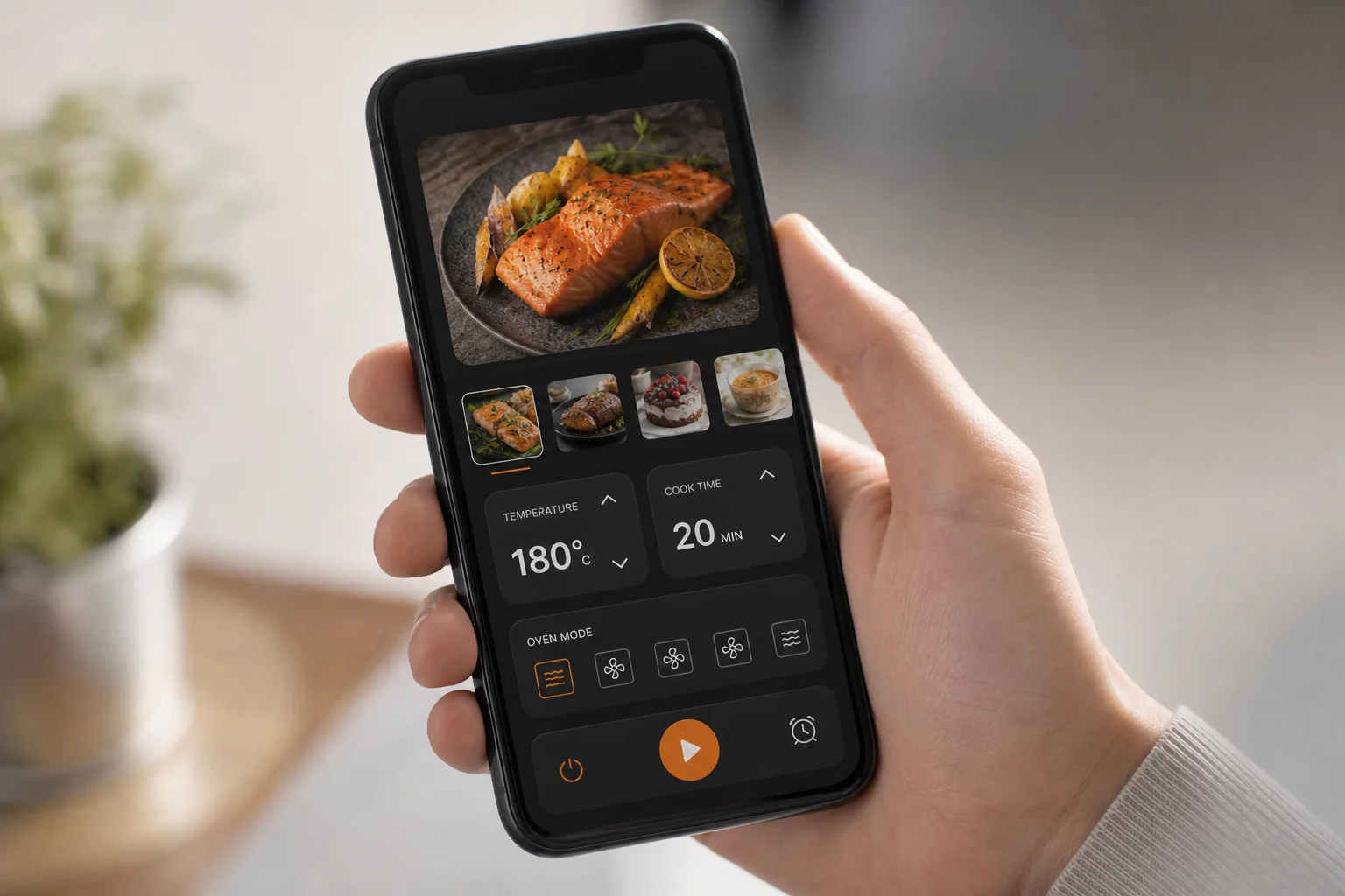 Smartphone affichant l'interface de l'application du four intelligent avec recettes et commandes