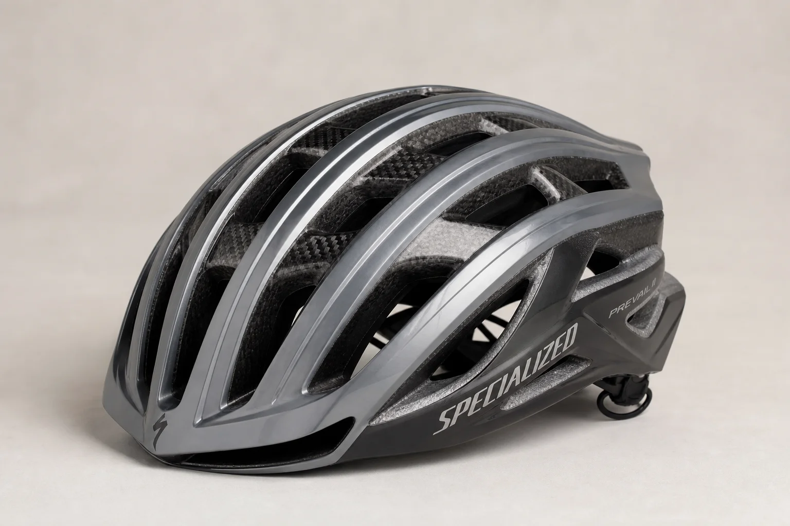 Five bike helmets of varying styles and price points arranged on concrete