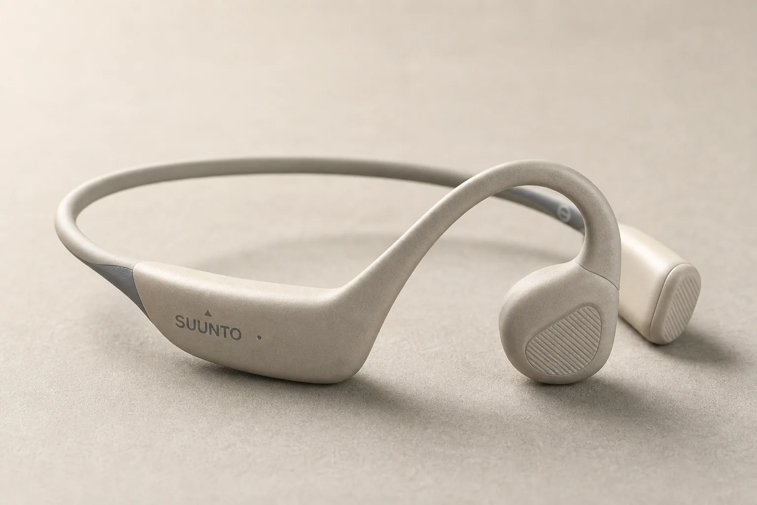 Six bone conduction headphones arranged on concrete surface showing different models and designs