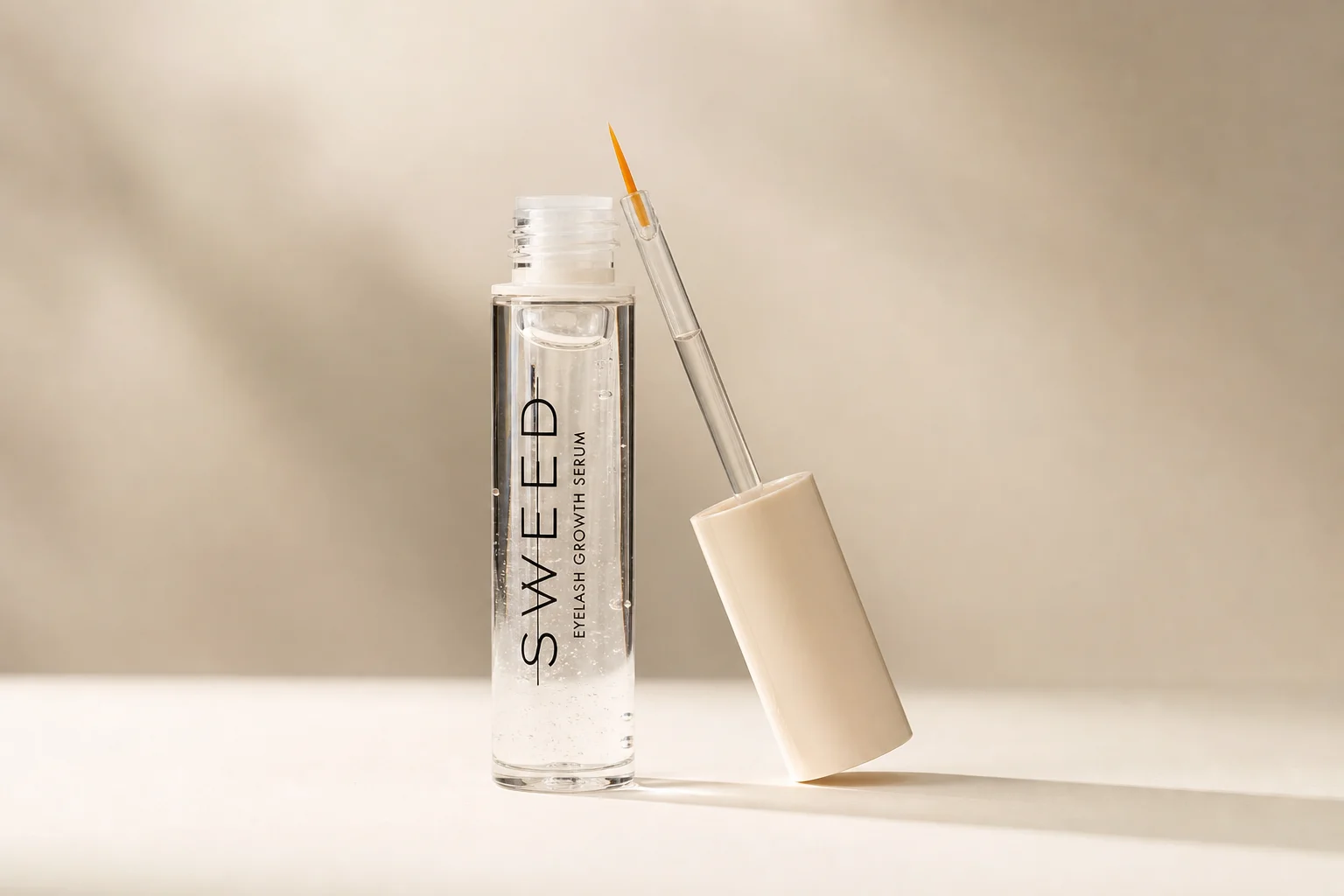 Sweed Beauty makeup collection arranged on concrete surface showing foundation, powder, blush, lipstick, and mascara