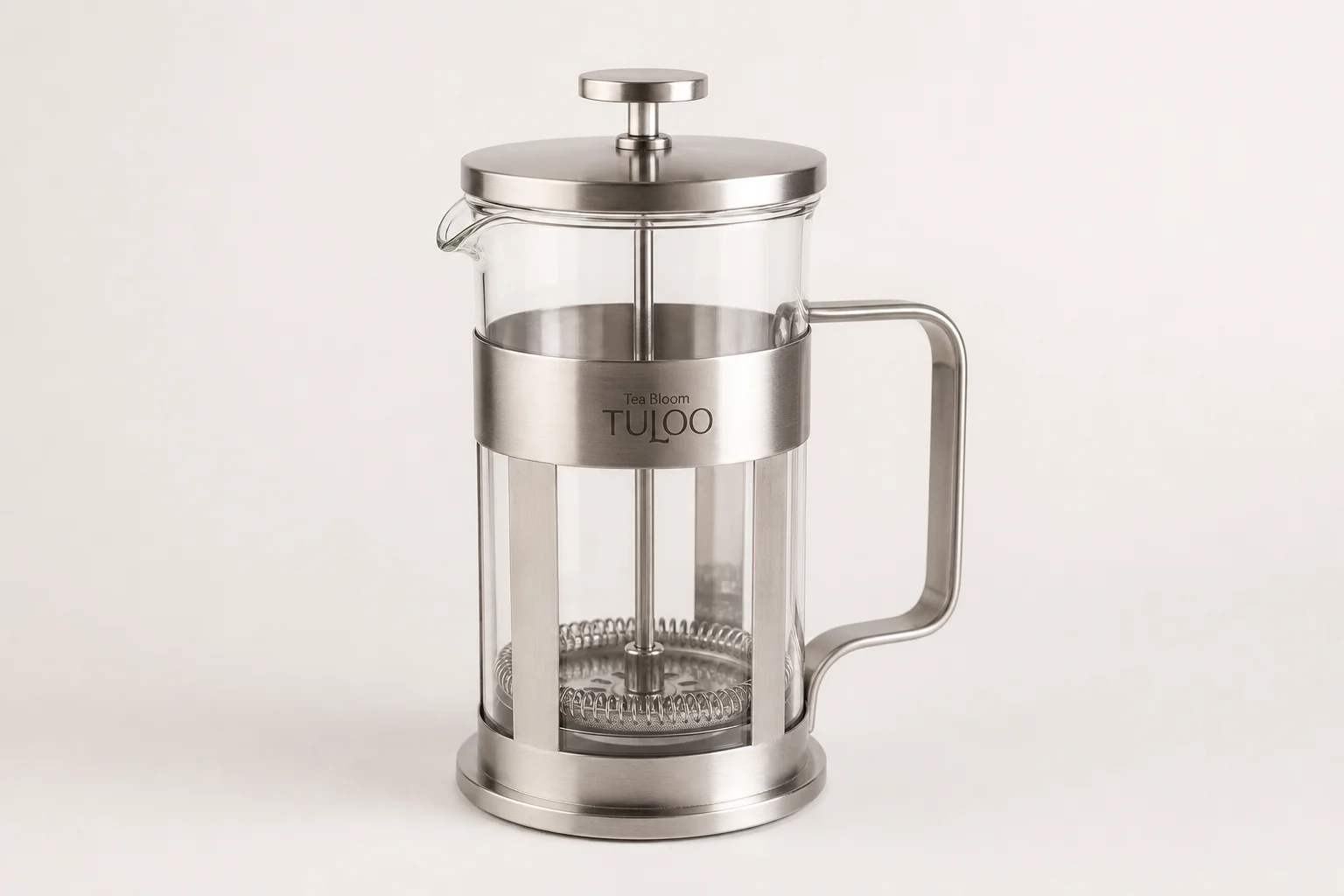 Five non-toxic French press coffee makers displayed on concrete surface