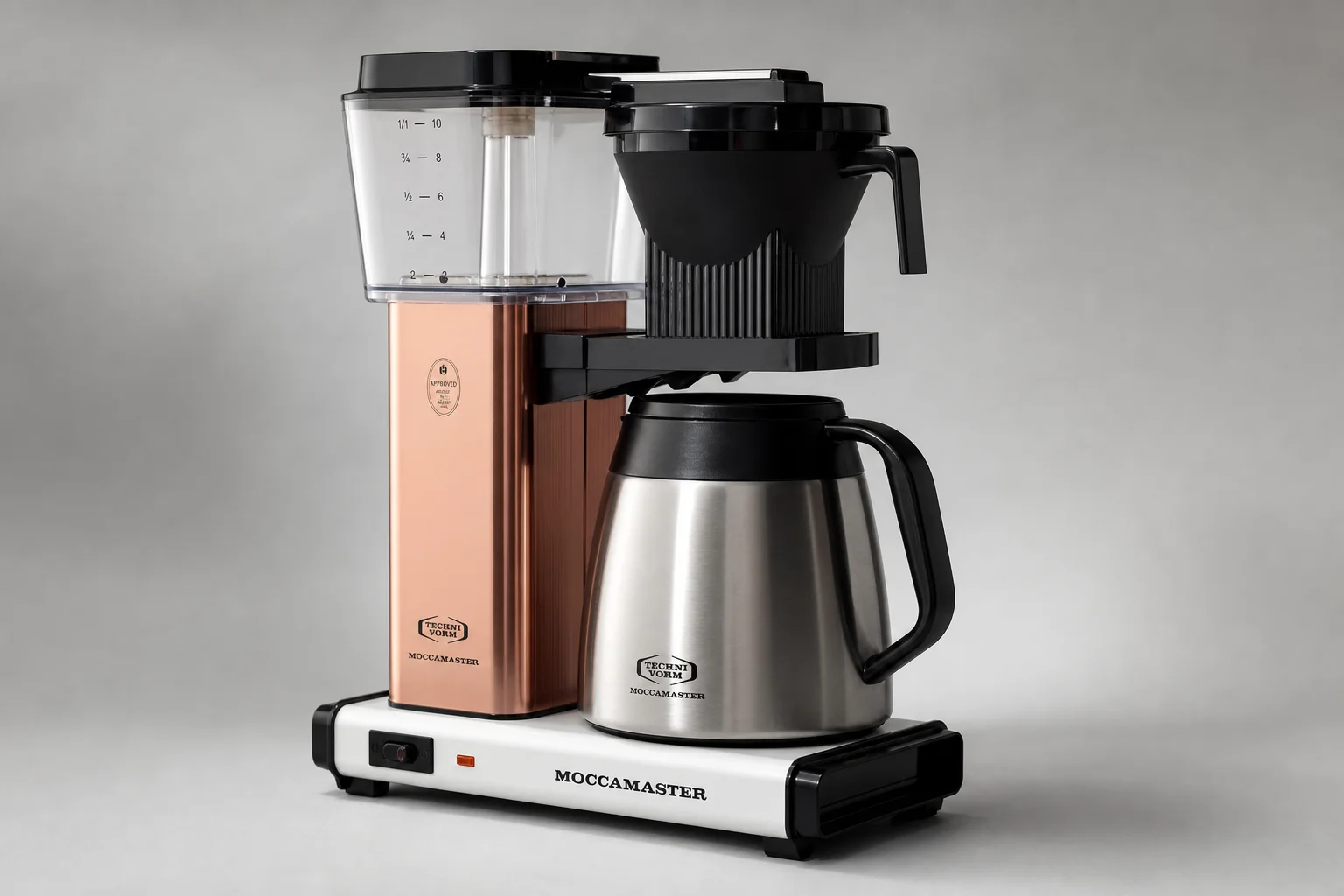 Six automatic coffee makers arranged in a line on concrete surface
