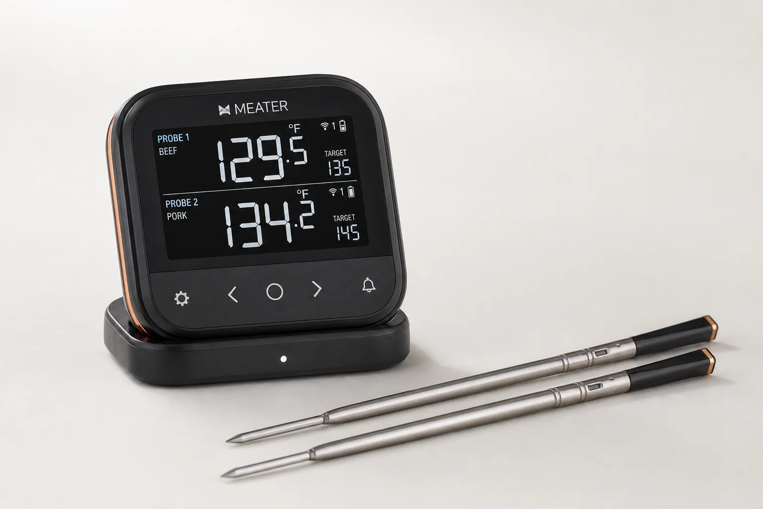Five meat thermometers arranged diagonally from budget to premium models on concrete