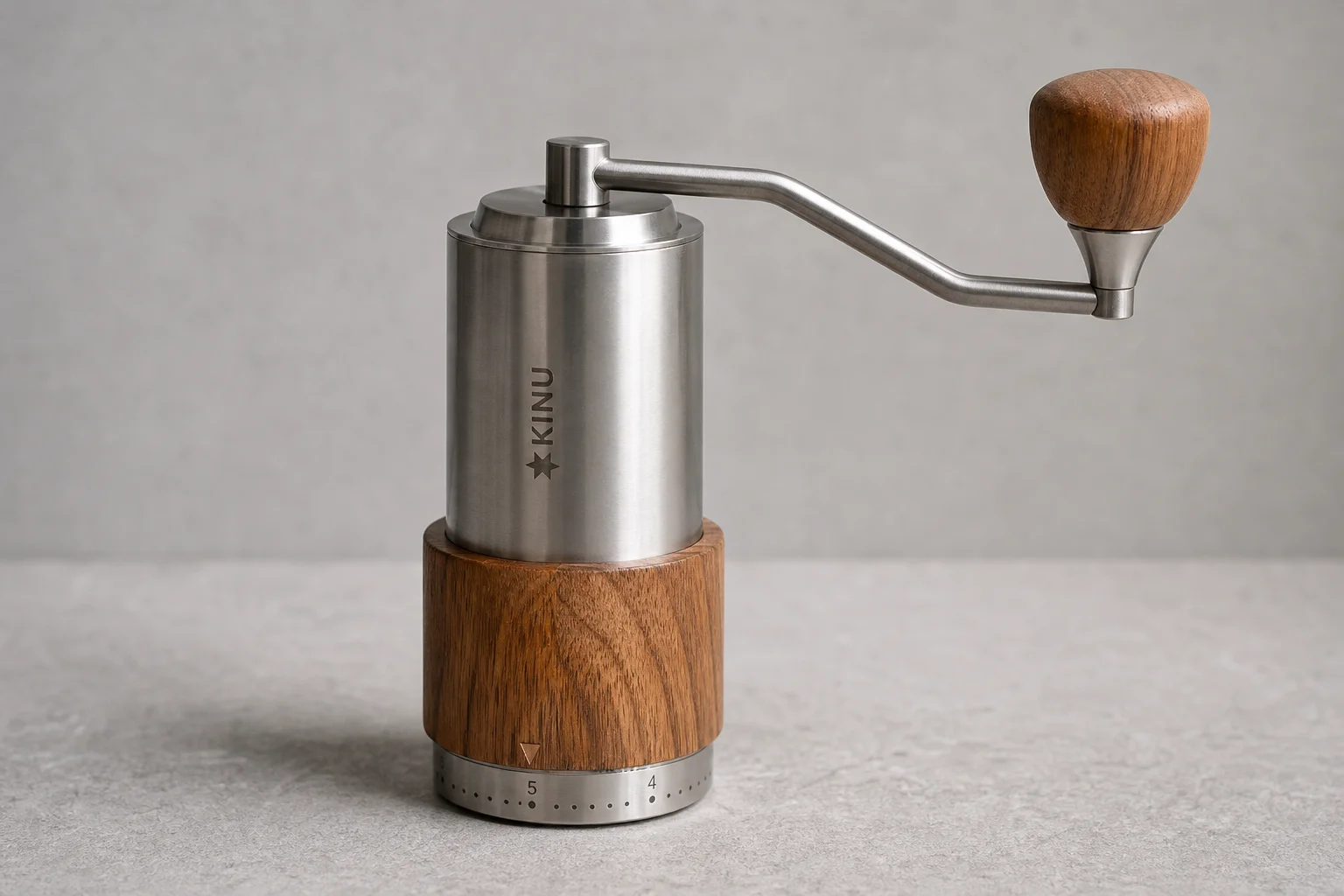 Seven premium hand coffee grinders arranged on concrete surface