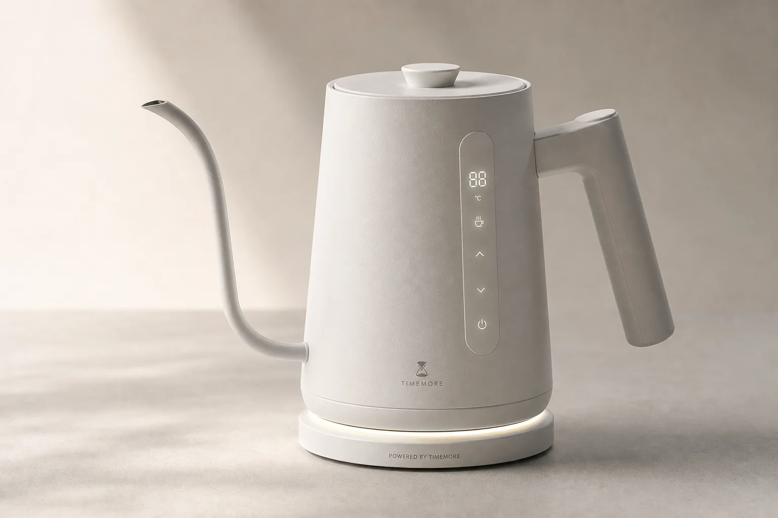 Eight electric gooseneck kettles arranged on concrete surface showing different designs and finishes