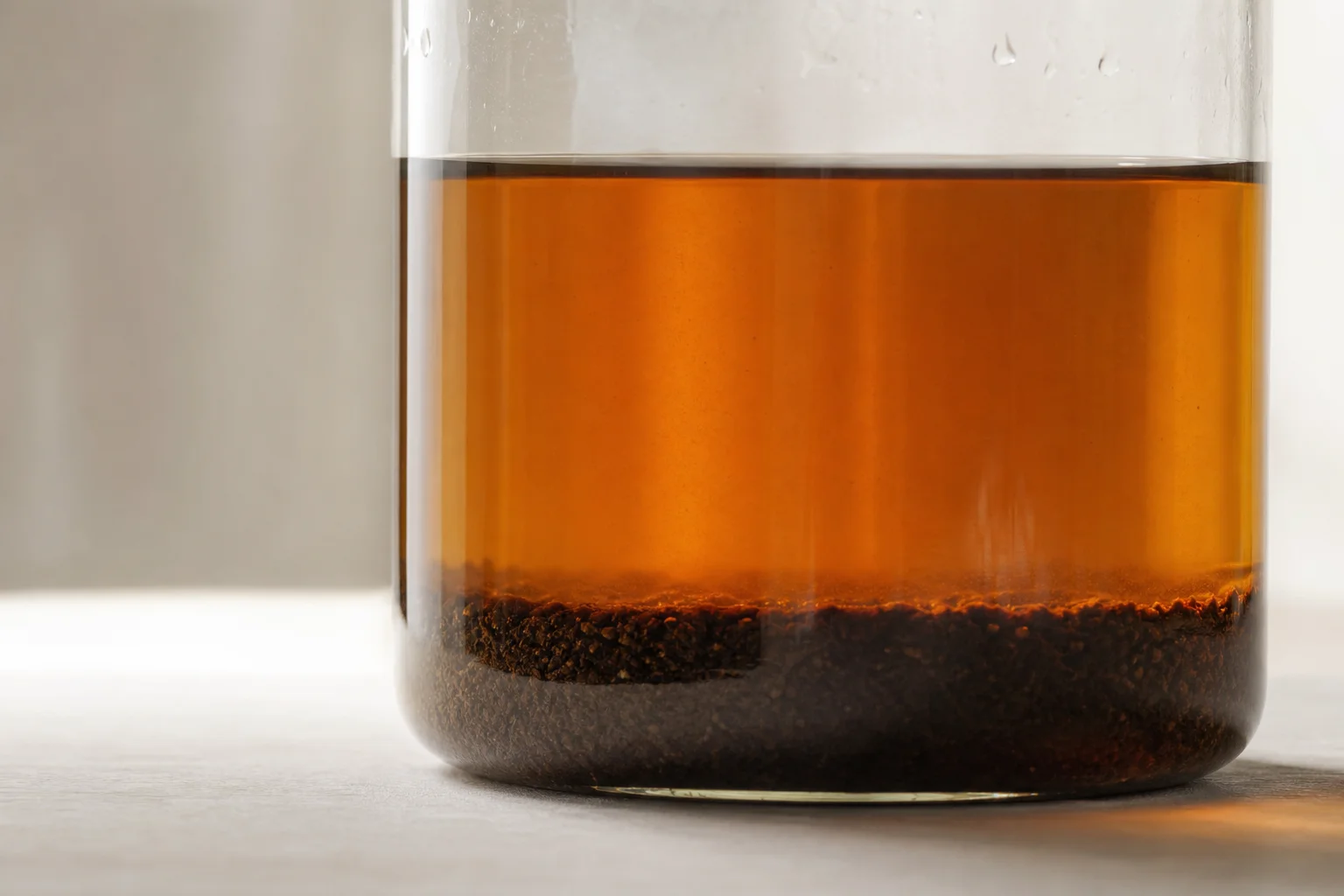 Cold brew with settled sediment at bottom and clear liquid above