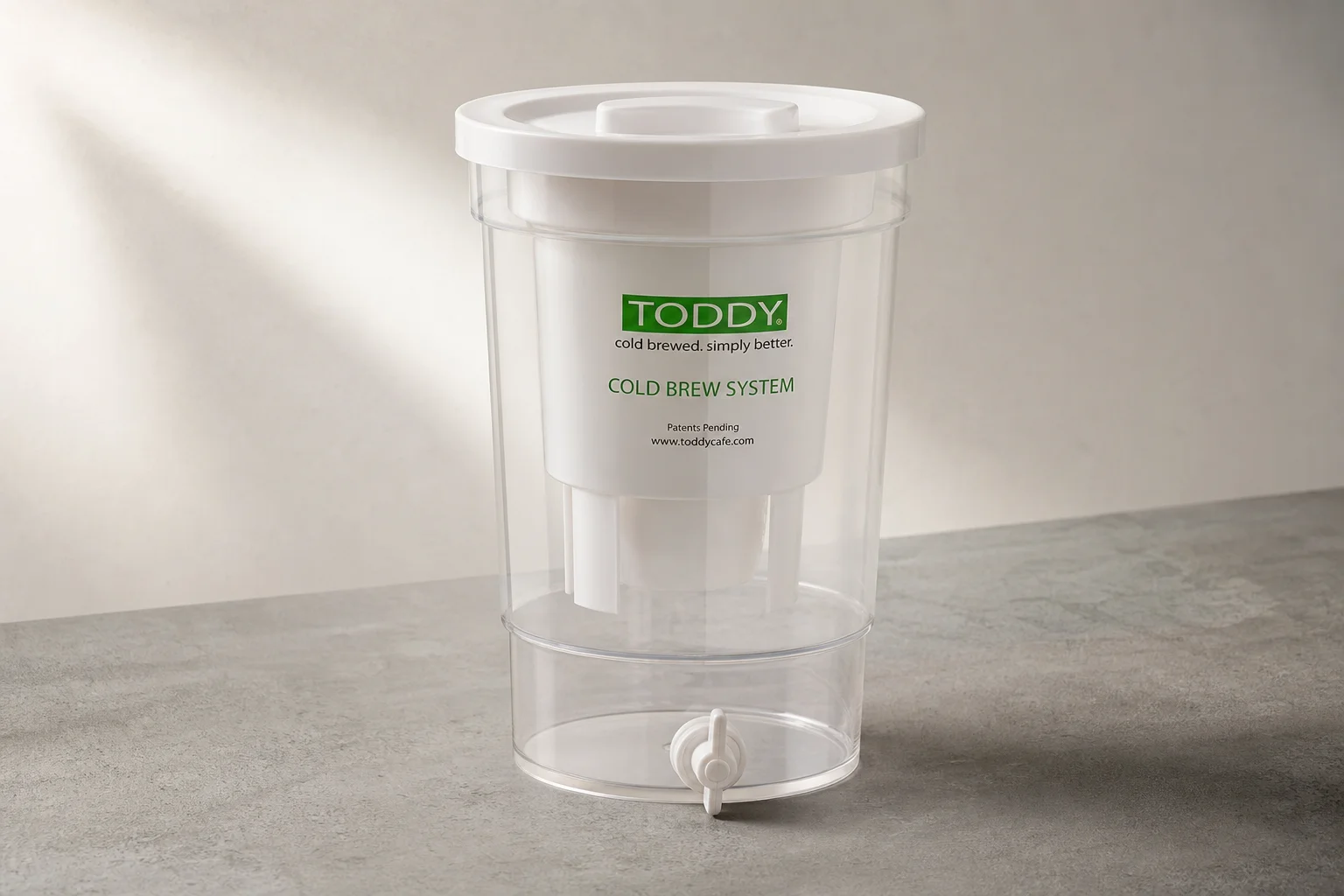 Toddy Cold Brew System bucket with filtration chamber and bottom valve on concrete