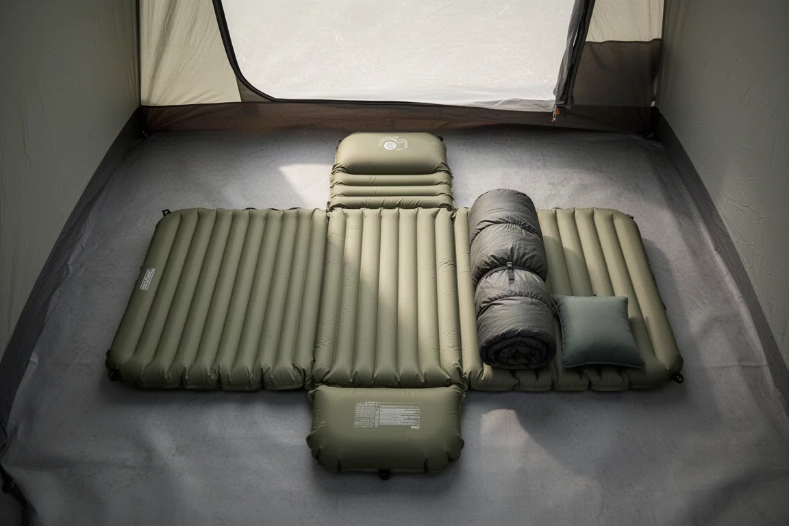 Wide sleeping pad laid out inside a tent with sleeping bag and pillow