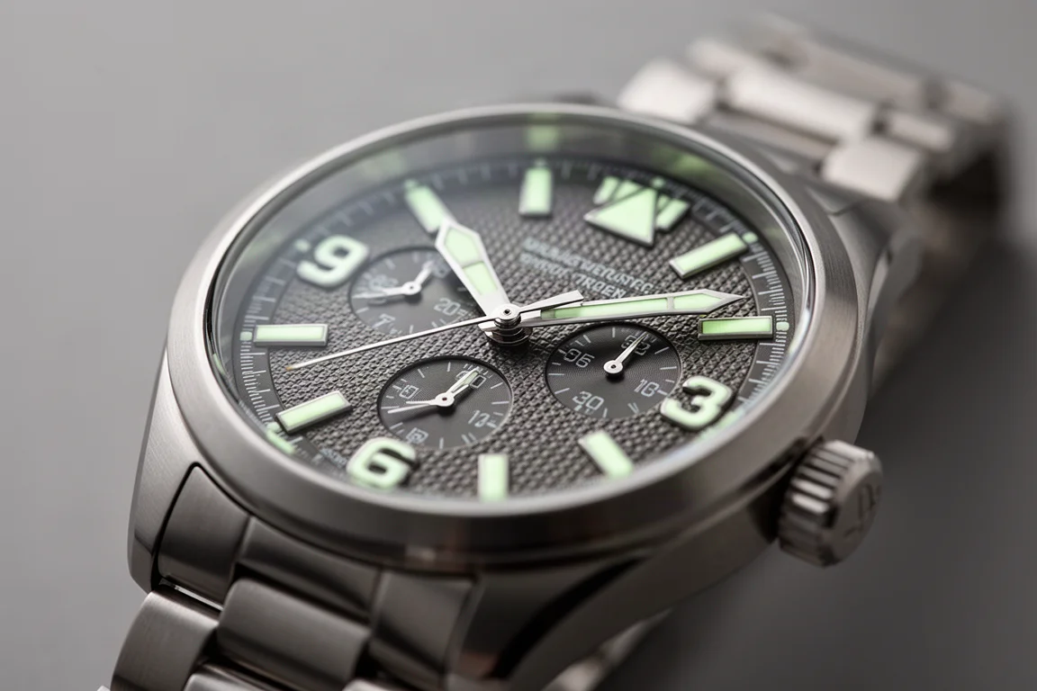 Close-up of a pilot watch with large luminous hour markers on a textured dial