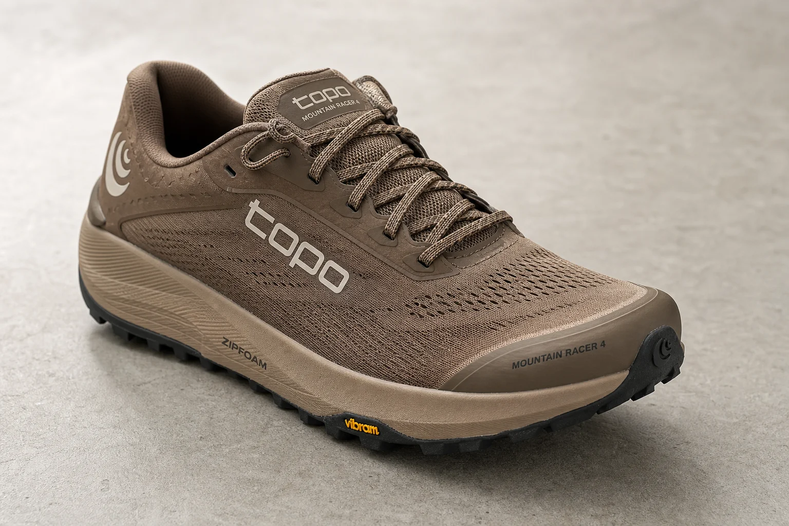 Seven trail running and hiking shoes arranged on concrete surface