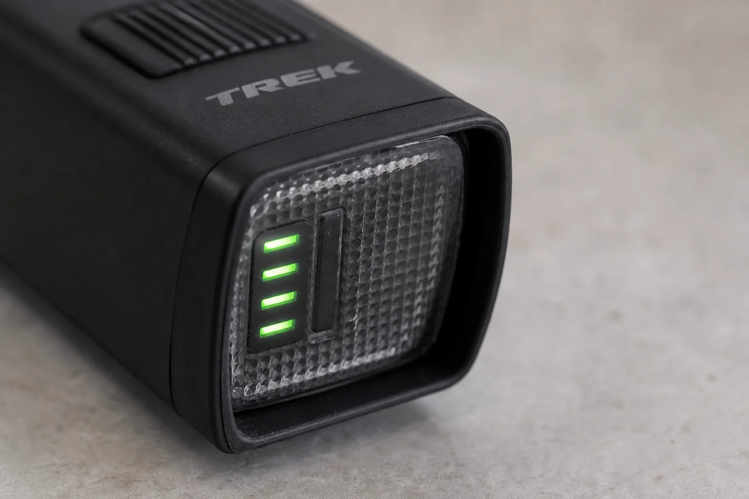 Close-up of bike light battery gauge showing four green LED bars