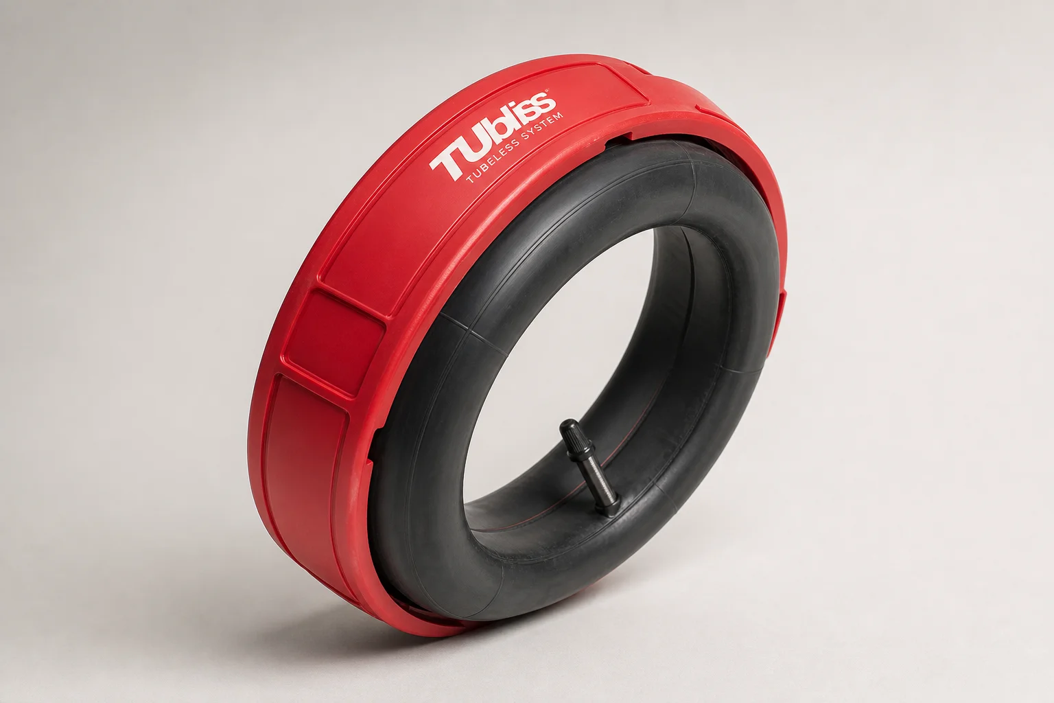 TUbliss tubeless system red plastic cover and high-pressure tube assembly on neutral backdrop