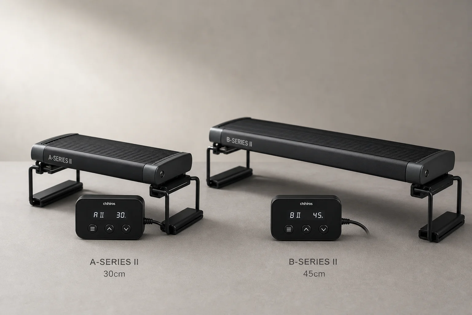 TwinStar A-Series II and B-Series II aquarium lights with controllers on grey surface