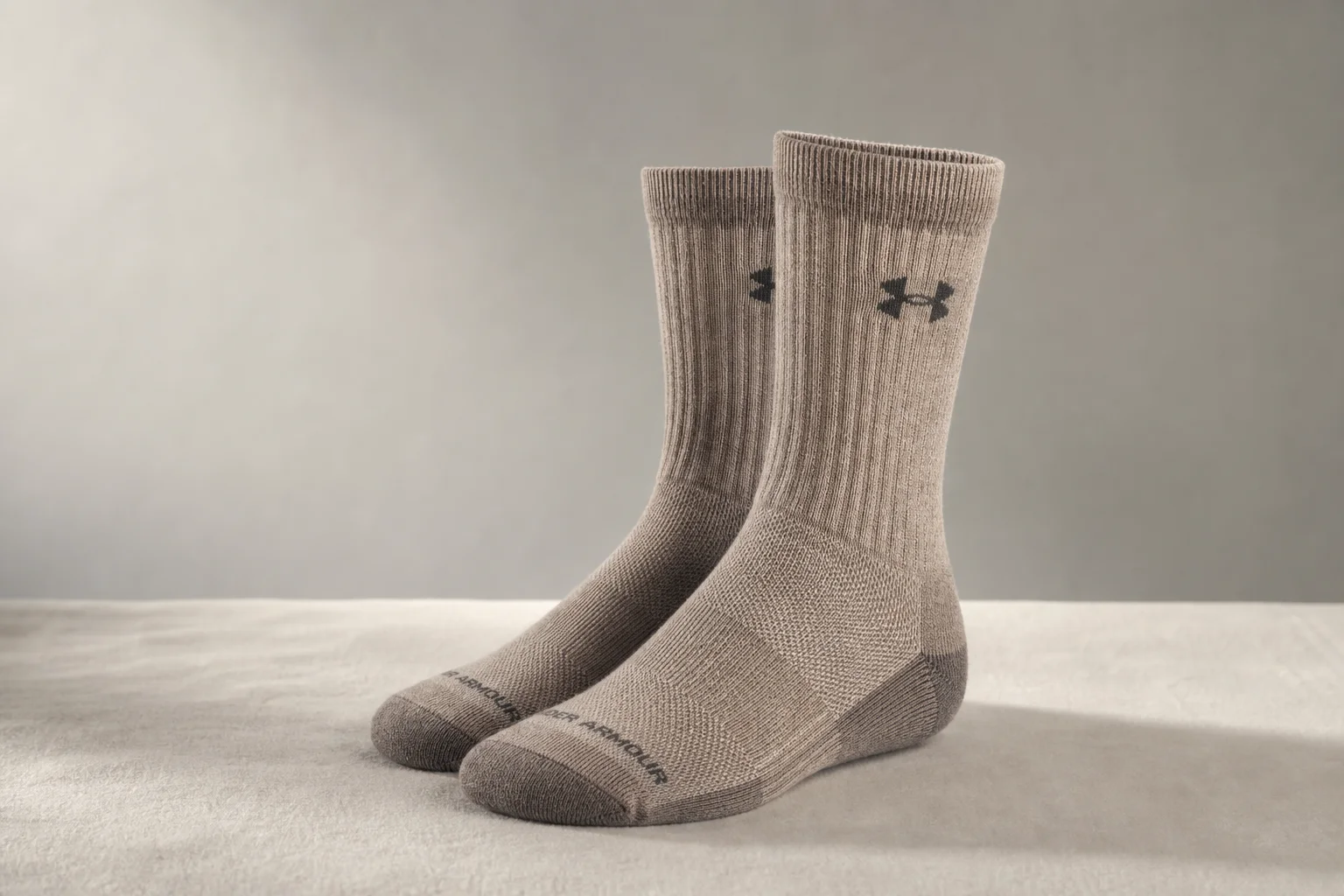 Collection of various running socks in different colors and styles on neutral backdrop
