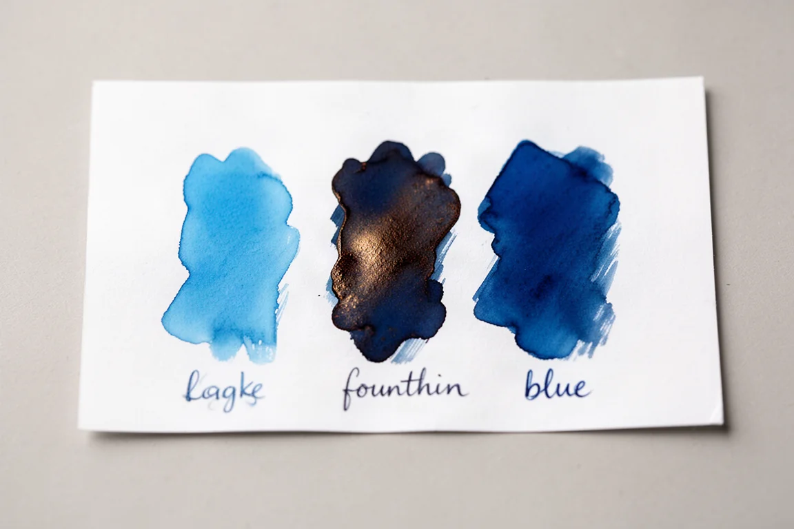 Three blue ink swatches side by side on white paper for comparison