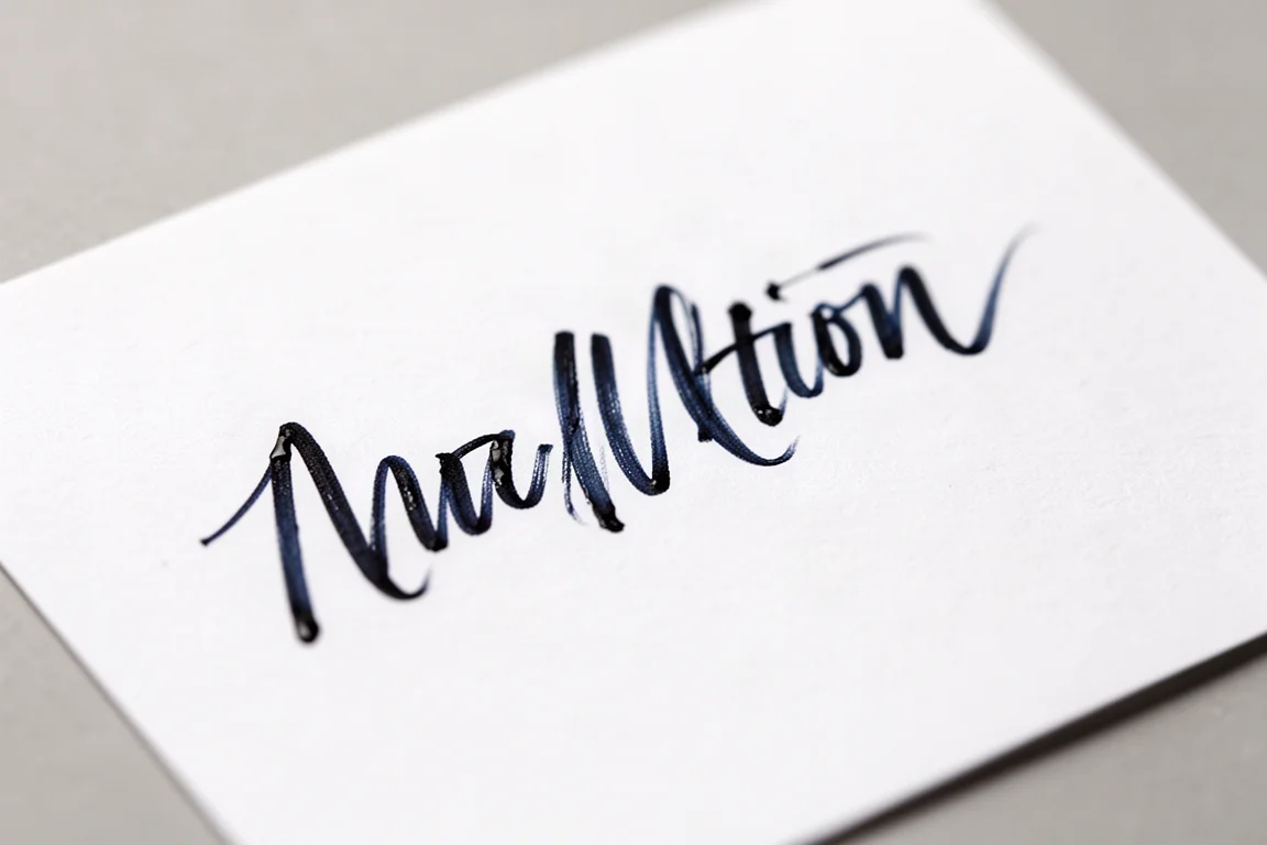 Blue black ink handwriting sample on white paper