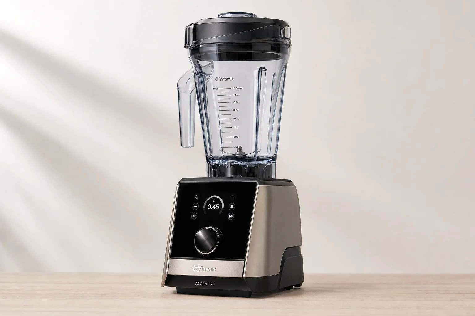 Five Vitamix blender models arranged by size and design progression on concrete