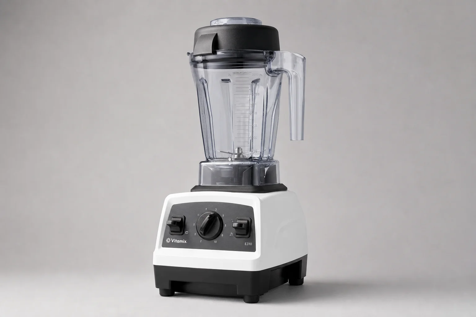 Five Vitamix blender models arranged by size and design progression on concrete