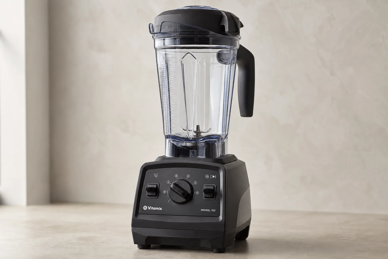 Five Vitamix blender models arranged by size and design progression on concrete