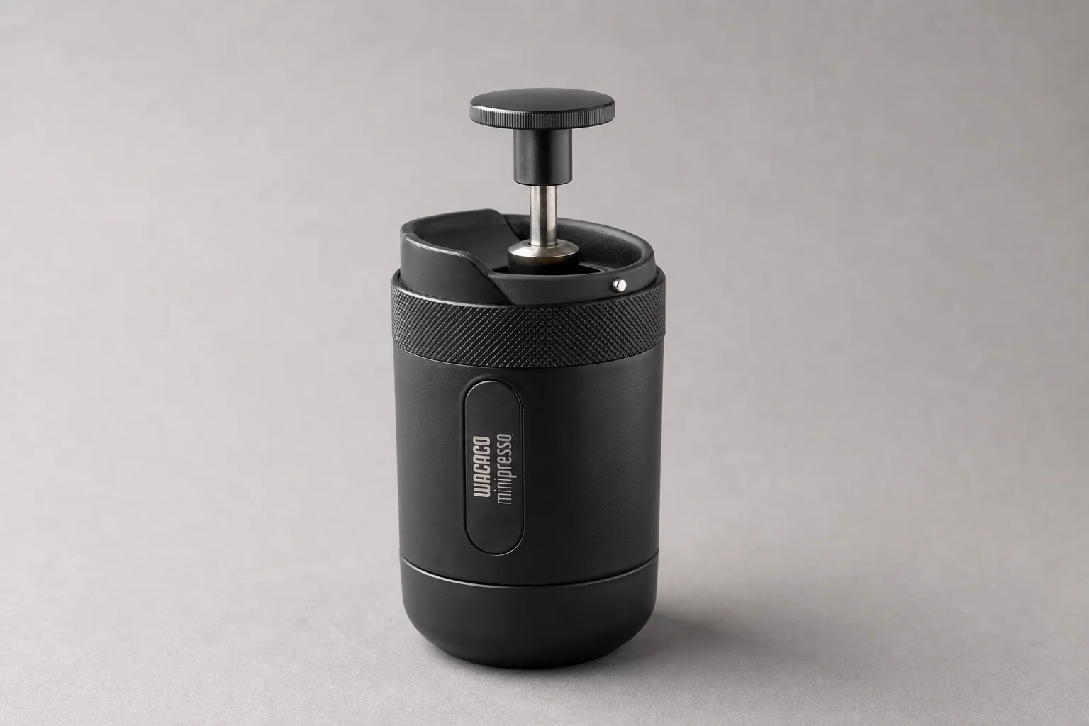 Wacaco Minipresso GR2 portable espresso maker on neutral grey background