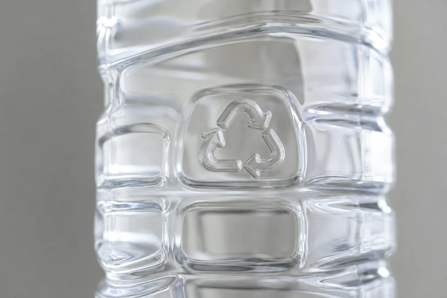 Close-up of plastic water bottle showing material composition and recycling symbol