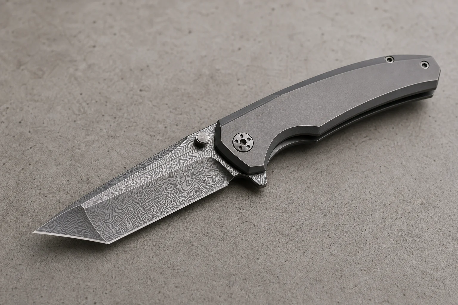 Premium folding knives with titanium handles and Damasteel blades on a dark slate surface