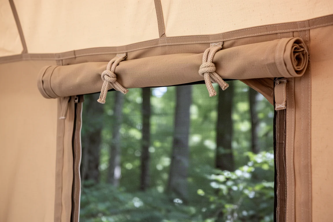 Tent wall rolled up and secured with toggles to reveal a mesh screen panel