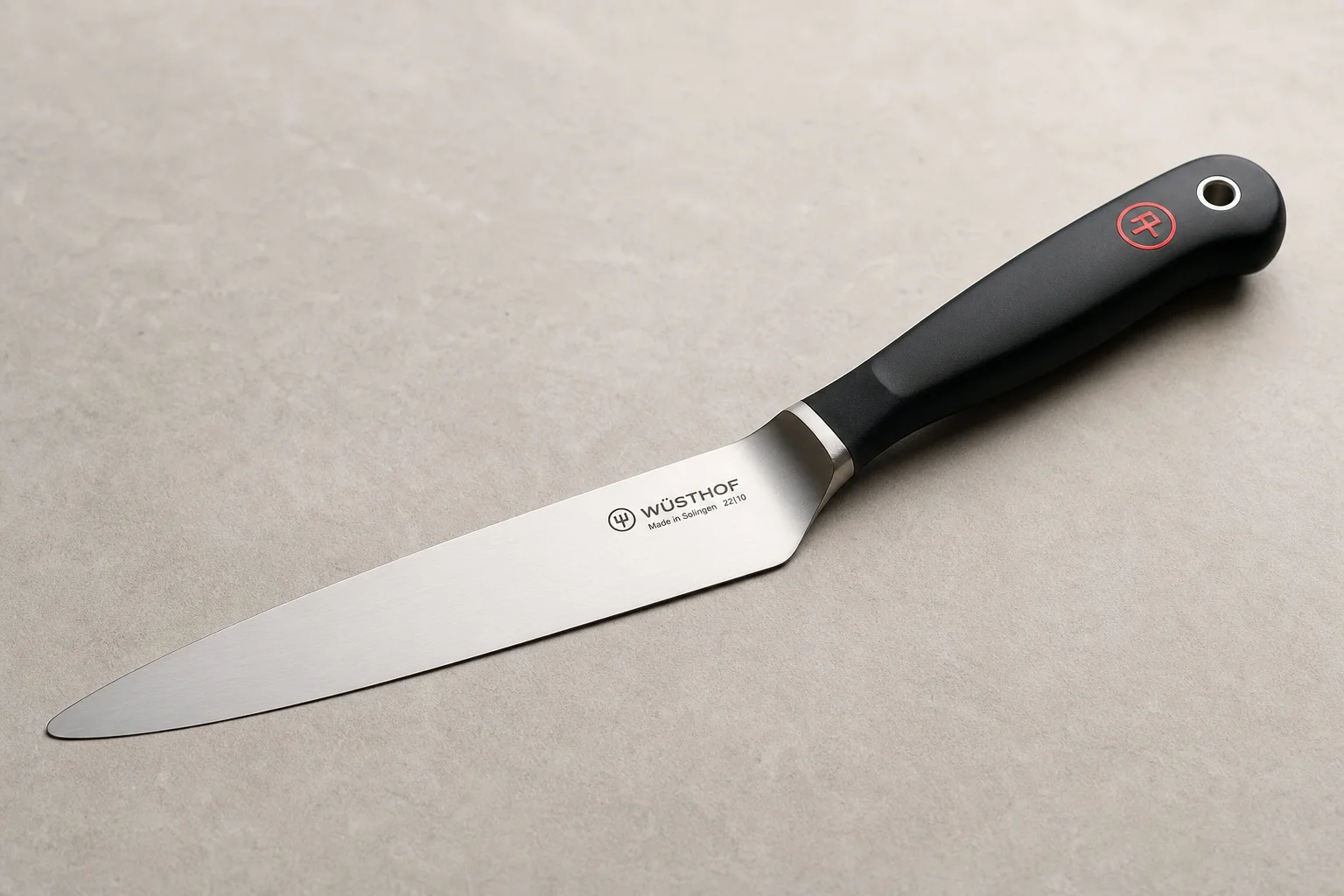 Eight essential kitchen tools arranged on a light wood surface