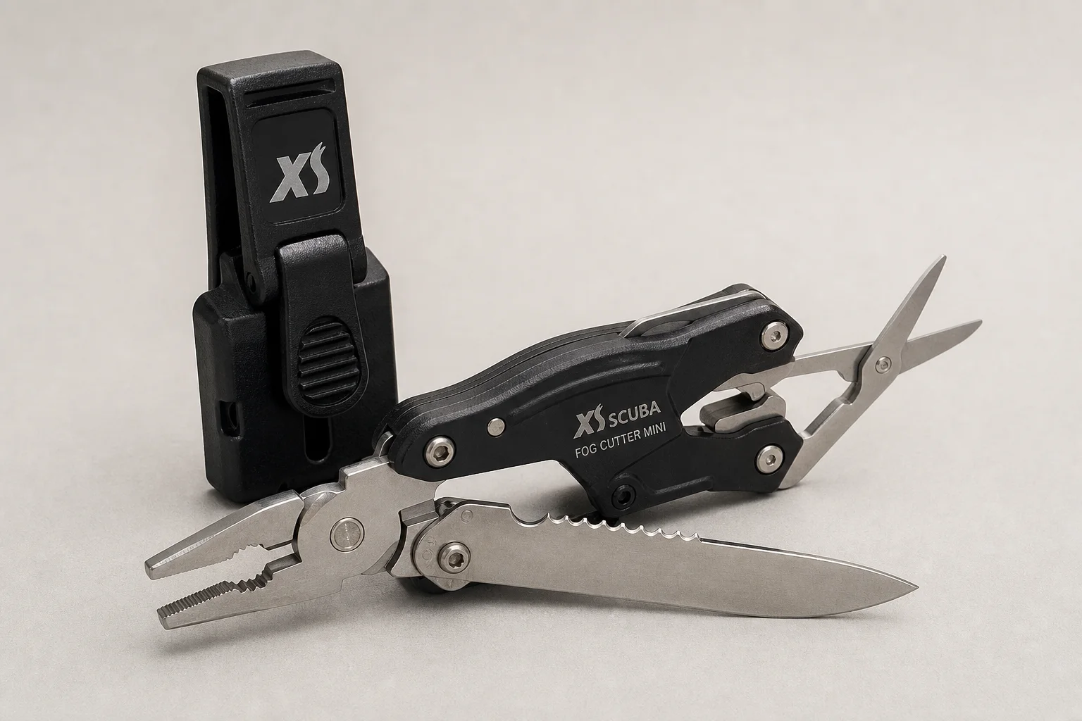 Collection of dive knives and cutting tools on concrete surface