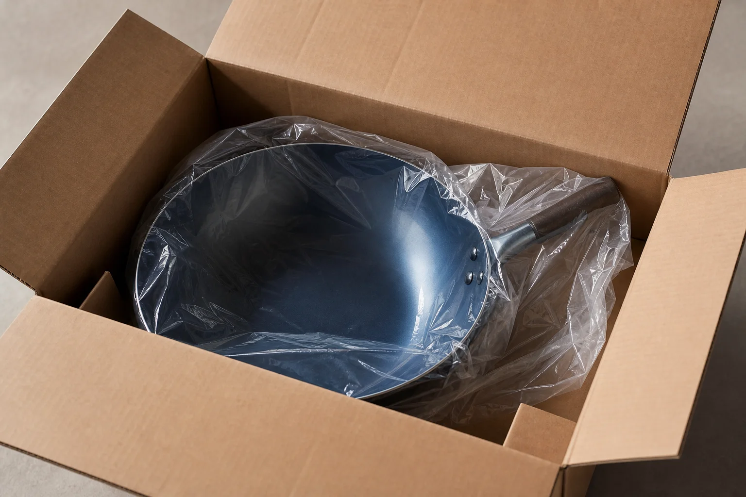 Unboxing a wok with minimal packaging and protective wrapping