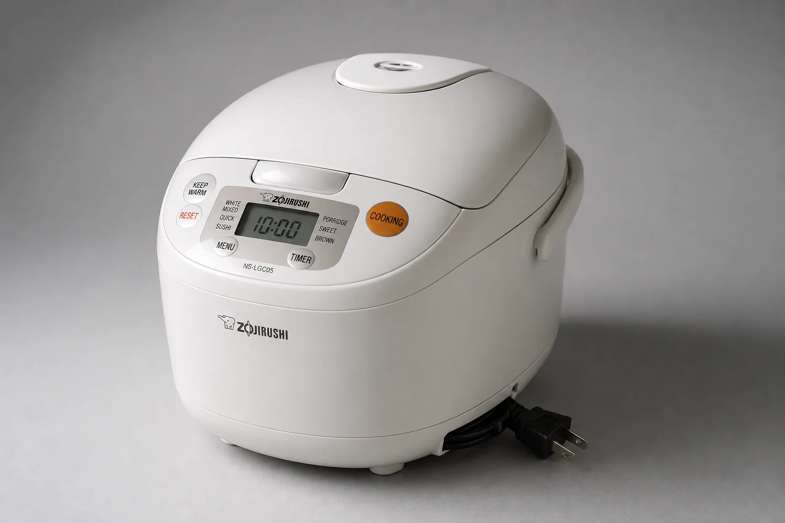 Five Zojirushi rice cookers arranged by size on concrete surface
